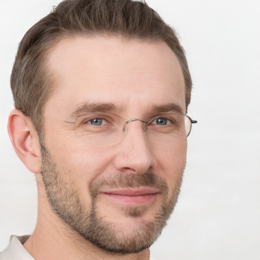 Joyful white adult male with short  brown hair and grey eyes