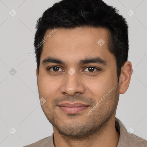 Joyful latino young-adult male with short  black hair and brown eyes