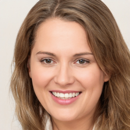 Joyful white young-adult female with long  brown hair and brown eyes