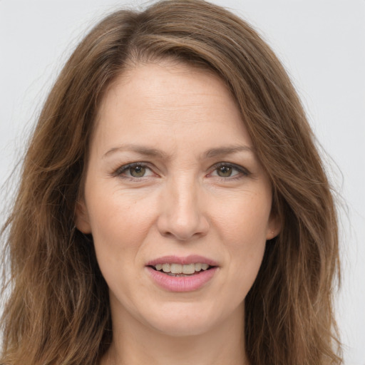 Joyful white adult female with long  brown hair and brown eyes