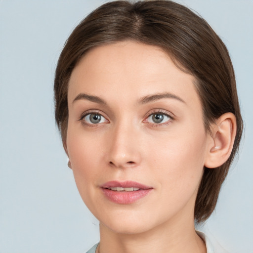 Joyful white young-adult female with medium  brown hair and grey eyes