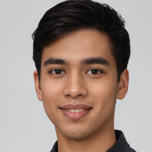 Joyful latino young-adult male with short  black hair and brown eyes