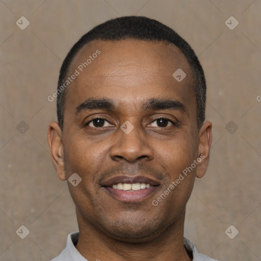 Joyful black young-adult male with short  black hair and brown eyes