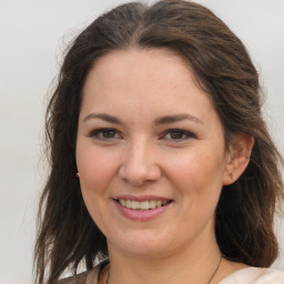 Joyful white young-adult female with medium  brown hair and brown eyes