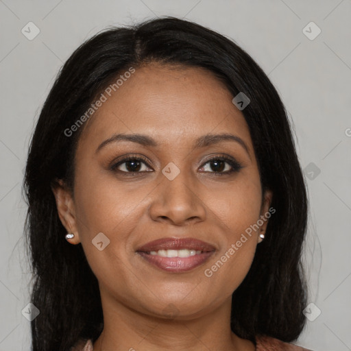 Joyful black young-adult female with long  brown hair and brown eyes