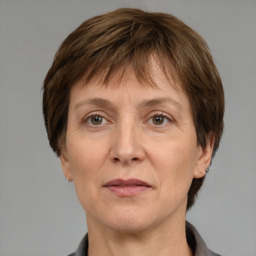 Joyful white adult female with short  brown hair and grey eyes