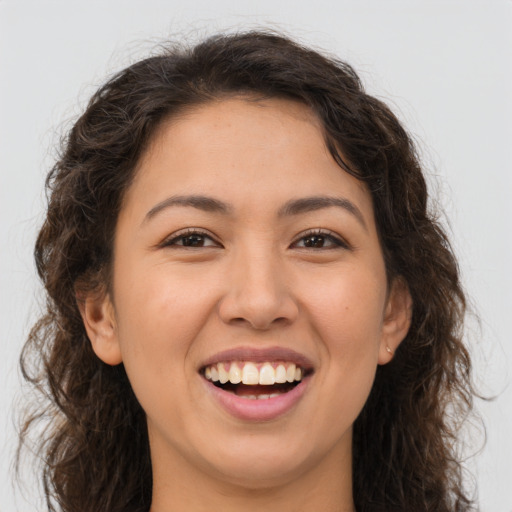 Joyful white young-adult female with long  brown hair and brown eyes