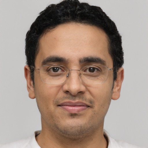 Joyful latino adult male with short  black hair and brown eyes