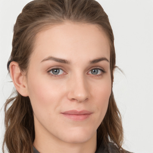 Joyful white young-adult female with long  brown hair and grey eyes