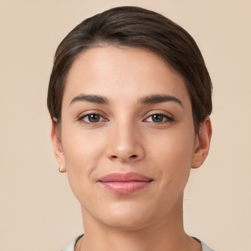 Joyful white young-adult female with short  brown hair and brown eyes