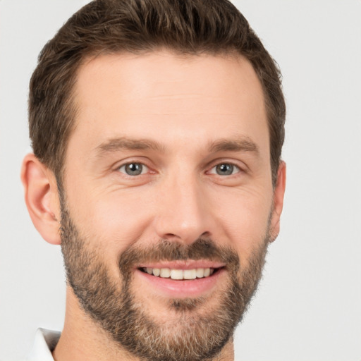 Joyful white young-adult male with short  brown hair and brown eyes