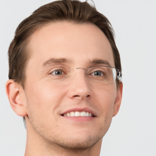 Joyful white young-adult male with short  brown hair and grey eyes