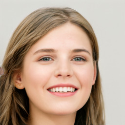 Joyful white young-adult female with long  brown hair and blue eyes