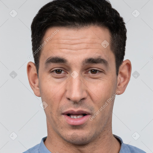 Joyful white young-adult male with short  black hair and brown eyes