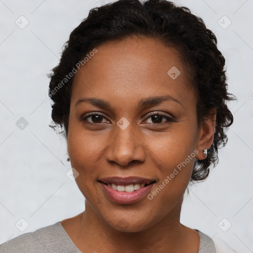 Joyful black young-adult female with short  brown hair and brown eyes