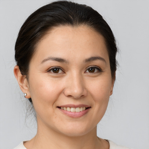 Joyful white young-adult female with medium  brown hair and brown eyes