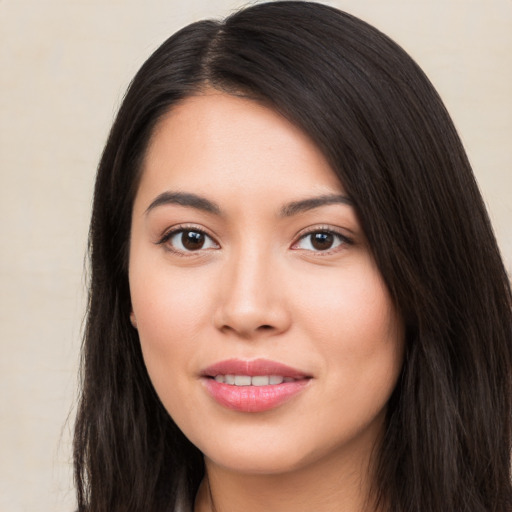 Joyful asian young-adult female with long  black hair and brown eyes