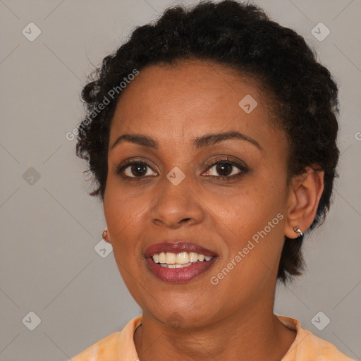 Joyful black young-adult female with short  brown hair and brown eyes