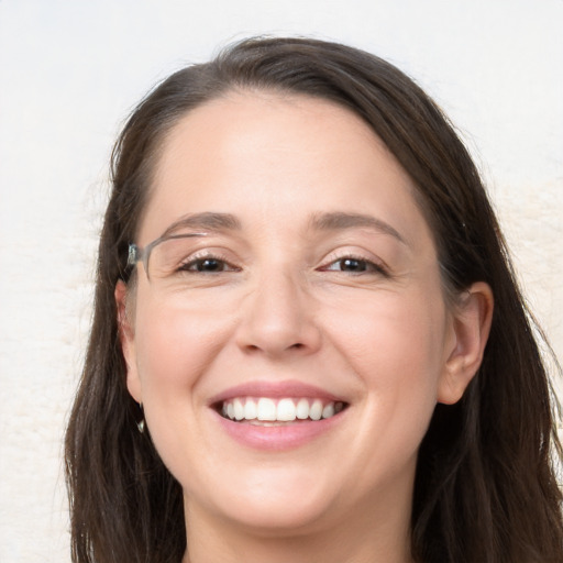 Joyful white adult female with long  brown hair and brown eyes