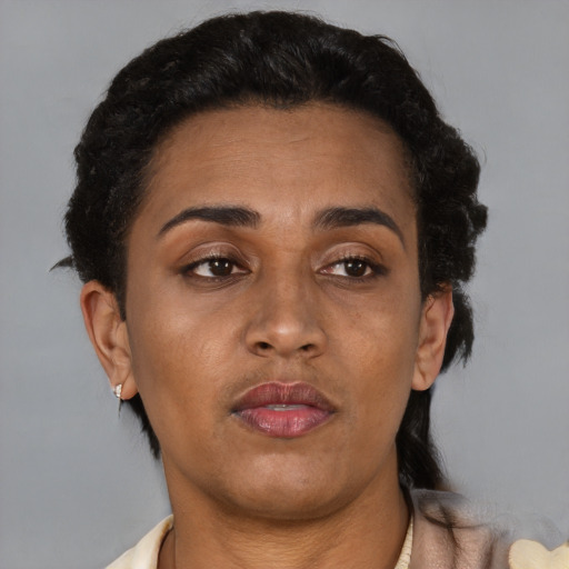 Neutral latino adult female with short  brown hair and brown eyes