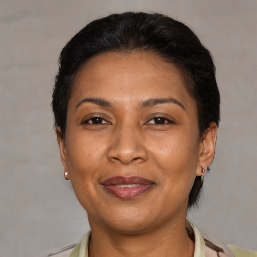 Joyful latino adult female with short  black hair and brown eyes