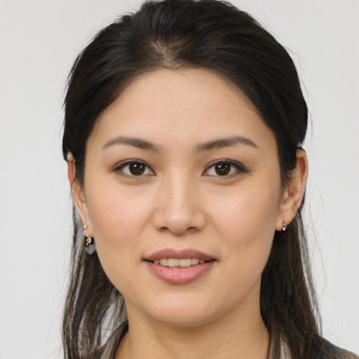 Joyful white young-adult female with long  brown hair and brown eyes