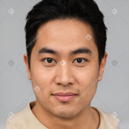 Joyful asian young-adult male with short  black hair and brown eyes