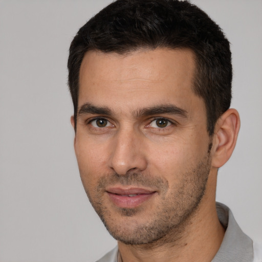 Joyful white young-adult male with short  brown hair and brown eyes