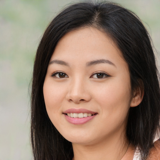 Joyful asian young-adult female with long  brown hair and brown eyes