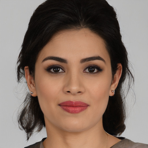 Joyful latino young-adult female with medium  black hair and brown eyes