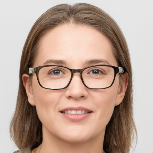 Joyful white young-adult female with long  brown hair and blue eyes