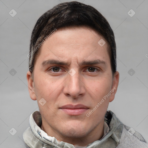 Joyful white young-adult male with short  brown hair and grey eyes