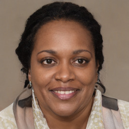 Joyful black adult female with medium  brown hair and brown eyes