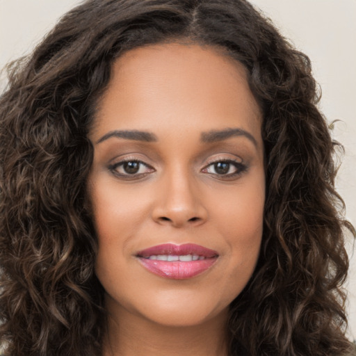 Joyful white young-adult female with long  brown hair and brown eyes