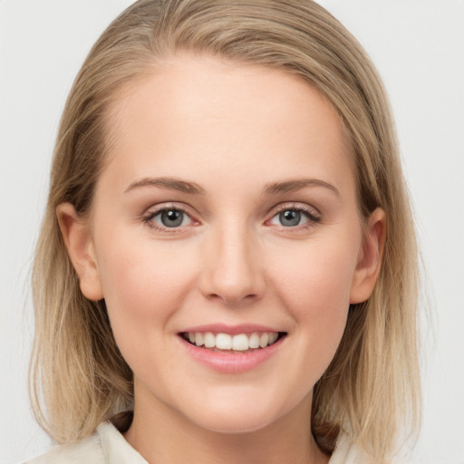 Joyful white young-adult female with long  brown hair and blue eyes