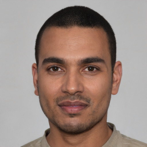 Joyful latino young-adult male with short  black hair and brown eyes
