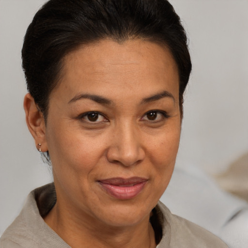 Joyful white adult female with short  brown hair and brown eyes