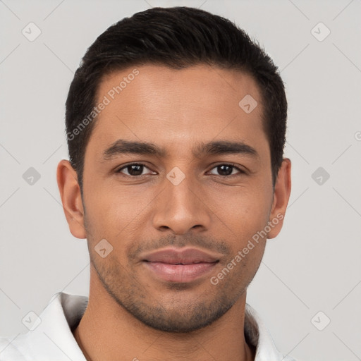 Joyful latino young-adult male with short  brown hair and brown eyes