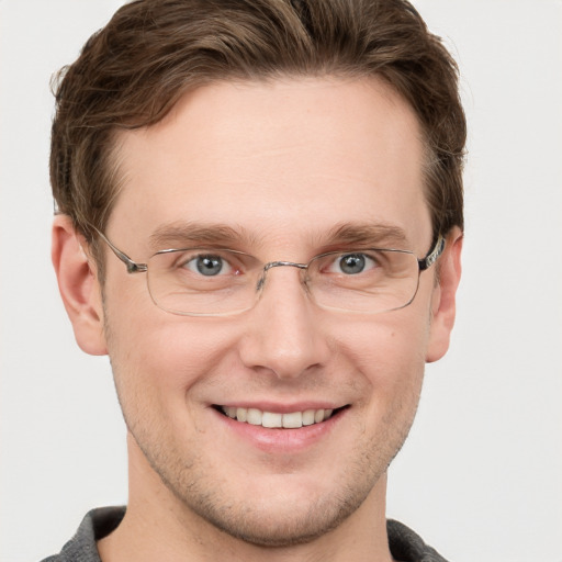 Joyful white adult male with short  brown hair and grey eyes