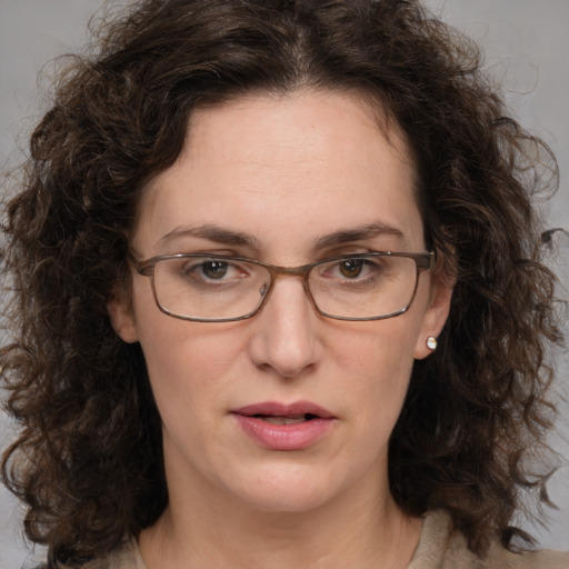 Joyful white adult female with medium  brown hair and green eyes