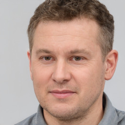 Joyful white adult male with short  brown hair and grey eyes