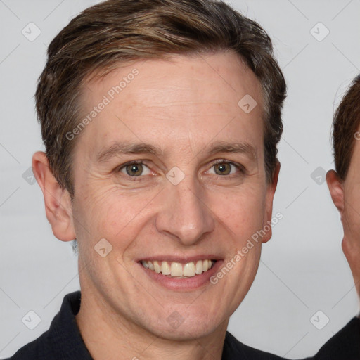 Joyful white adult male with short  brown hair and grey eyes