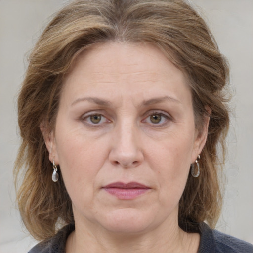 Joyful white adult female with medium  brown hair and grey eyes