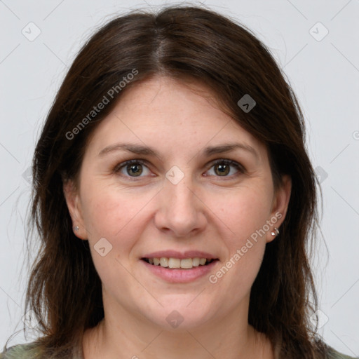 Joyful white adult female with long  brown hair and brown eyes