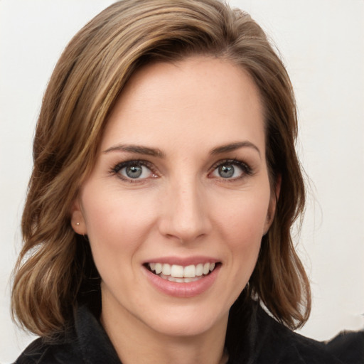 Joyful white young-adult female with long  brown hair and green eyes