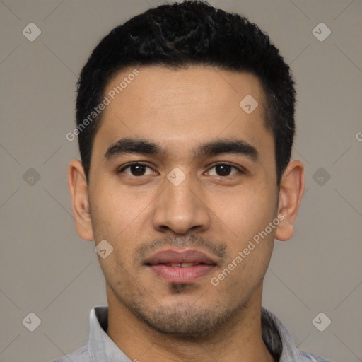 Joyful latino young-adult male with short  black hair and brown eyes