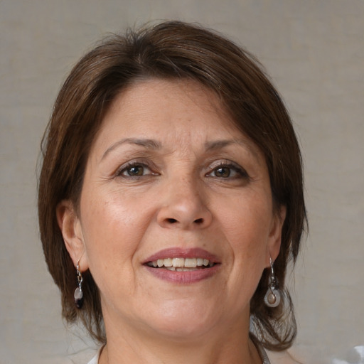 Joyful white adult female with medium  brown hair and brown eyes