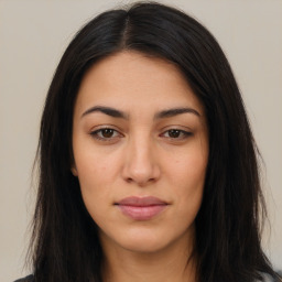 Joyful latino young-adult female with long  brown hair and brown eyes