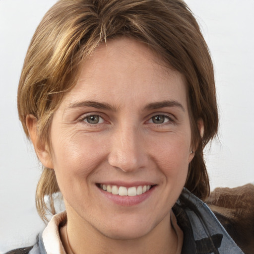 Joyful white young-adult female with medium  brown hair and grey eyes