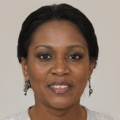 Joyful black adult female with short  brown hair and brown eyes